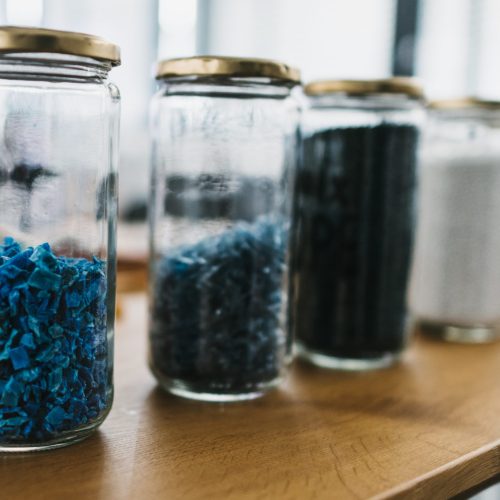 shredded plastic in glass containers for a workshop